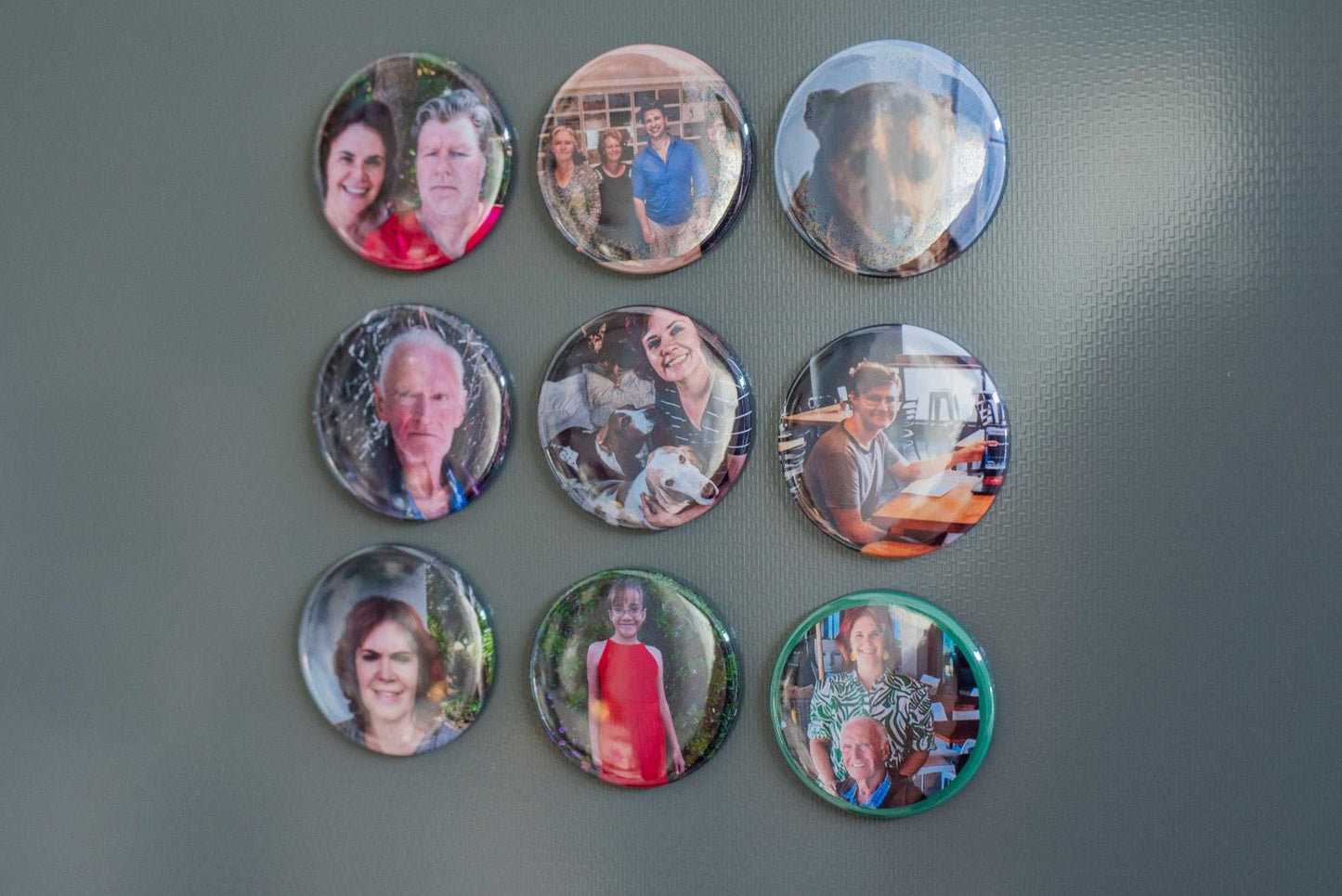 9 magnets with personal photos on a fridge